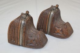 A pair of carved walnut Chilean stirrups, 9in., a pair of South American conquistador brass stirrups