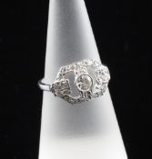 An Art Deco style 18ct white gold and diamond set cluster ring, of openwork hexagonal design, size