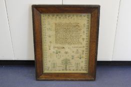 An early 19th century needlepoint sampler, named and dated Elizabeth Penkett, aged 18, 1819, with