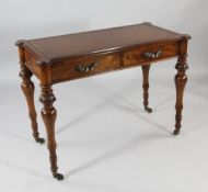 A Victorian walnut two drawer writing table by W.C Burt, Torquay, with rectangular leathered writing