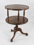 A George III mahogany two tier circular revolving dumb waiter, with reeded borders and reeded