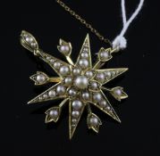 An Edwardian 15ct gold and seed pearl set starburst pendant brooch, 1.25in.