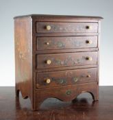 A 19th century miniature mahogany chest, of four long graduated drawers, painted with ribbon tied