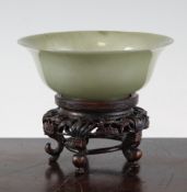 A Chinese green jade bowl, 19th century, with slightly everted rim and circular foot ring, 13.3cm,