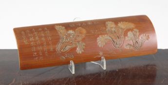A Chinese bamboo wrist rest, carved in bas-relief with pakchoi, and inscribed, 25cm.