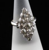 An Edwardian 18ct gold marquise shaped diamond cluster ring, set with fifteen graduated old cut