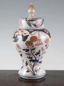 A Japanese Arita baluster vase and cover, early 18th century, painted with blossoming branches,