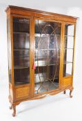 An Edwardian satinwood and rosewood cross banded display cabinet, with central astragal glazed