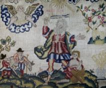 A 17th century rectangular needlework panel, with a central bearded figure holding a sword aloft