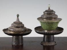 A pair of Sino-Tibetan silver stands and covers, late 19th century, lacking porcelain or jade bowls,