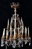 A large 19th century French ormolu chandelier, with six double scroll arms and thirty circular