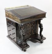 A 19th century Anglo Indian calamander davenport, with fret pierced panel front, two scroll legs,