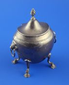 An Edwardian silver tea caddy, of cauldron shape, with ring handles and flambe finial, on four