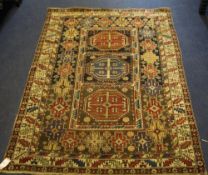 A Shirvan Baku rug, with three central octagonal medallions within a hooked border, in a field of