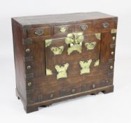 A Japanese / Korean elm cabinet, with brass mounts, fitted four frieze drawers and single drop