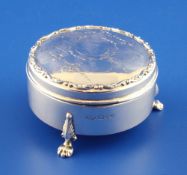 A George V silver circular trinket box, engraved with swags and musical trophies, Robert William