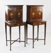 A pair of Edwardian mahogany and marquetry inlaid side cabinets, each decorated with scrolls,