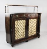 An early 19th century rosewood chiffonier, the raised back with three quarter pierced brass