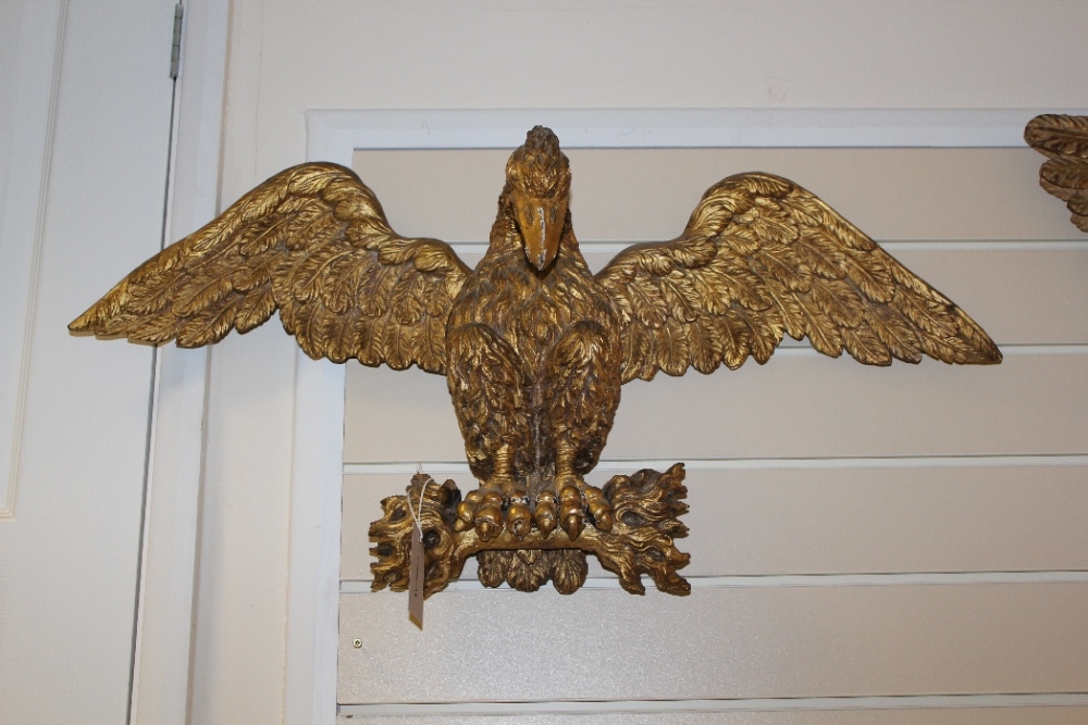 A Victorian carved giltwood wall appliqué, modelled as an eagle with outstretched wings, 31.5in.