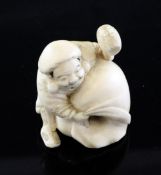 A Japanese ivory netsuke of Daikoku, Meiji period, the crouching god holding a mallet in his left