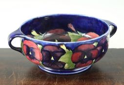 A Moorcroft Pansy pattern twin handled bowl, c.1925, with a cobalt blue ground, inscribed W.