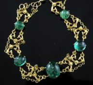 A gold and graduated cabochon emerald bracelet, set with round and oval cabochons with a total