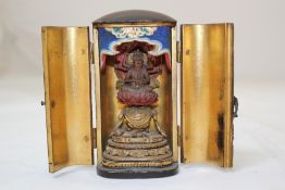 Two Japanese lacquer zushi (travelling shrine), 19th century, the first gilt decorated with