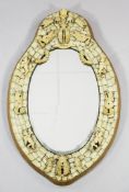 A 19th century Dieppe ivory wall mirror, with central oval bevelled plate glass, the frame applied