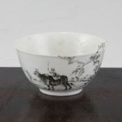 A Worcester grisaille `boy on a buffalo` pattern tea bowl, c.1754, picked out in black enamels in
