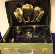 A George V travelling toilet case with 9ct gold mounted accessories, comprising seventeen gold