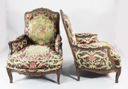 A pair of French Regence style carved beech armchairs, with figural needlepoint upholstery and