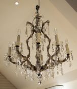 A Venetian style cut glass and brass eight branch chandelier, with flowerhead motifs and pear shaped