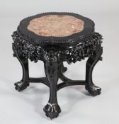 A late Victorian Chinese carved rosewood urn stand, with rouge marble inset top, on scroll legs with
