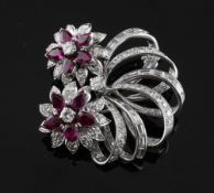 A white gold, ruby and diamond openwork scroll brooch with floral clusters, 1.75in.