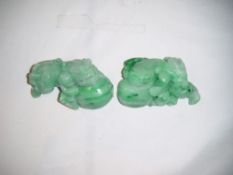 Two Chinese jadeite carvings of lion-dogs and balls, both colour treated, 6.5cm