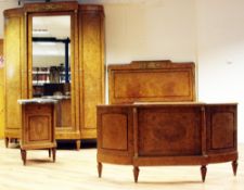 An early 20th century French birds eye maple three piece bedroom suite, includes a triple wardrobe