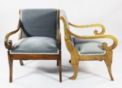 A pair of 19th century French walnut open armchairs, with scroll arms and sabre front supports