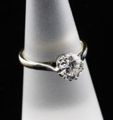 An 18ct gold and platinum solitaire diamond ring, the round cut stone weighing approximately 0.90ct,