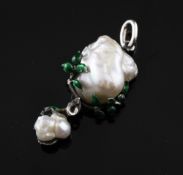 A silver and green enamel mounted natural baroque pearl drop pendant, in a foliate setting, with Gem
