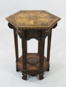 A Victorian carved oak hexagonal lamp table, the top inlaid with six coats of arms within openwork