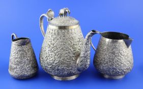 A matched 19th century Indian silver three piece tea set, of tapering circular form, comprising