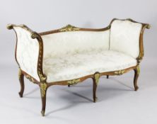 A Louis XV style carved walnut and parcel gilt scroll end window seat, with pale damask