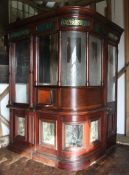 An unusual late Victorian part glazed mahogany cash booth, the cornice inset verre eglomise panels