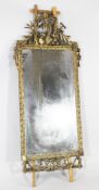 A 19th century Continental carved giltwood wall mirror, with cornucopia, ear of corn, trident and