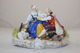 A German porcelain group, early 20th century, modelled as a lady and gentleman in 18th century