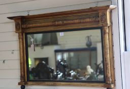 An early 19th century gilt-framed landscape overmantel mirror, with reel moulded columns and stiff
