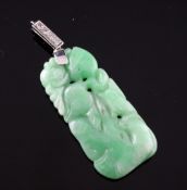 A carved jadeite pendant with diamond set white gold bale, overall 2in.