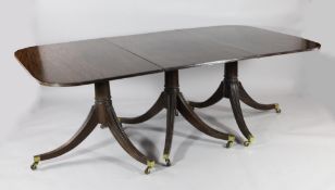 A Regency design triple pillar mahogany extending dining table, with two extra leaves, on turned