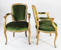 A set of four late 19th century French fruitwood open armchairs, with cartouche shaped backs and
