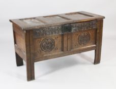 An 18th century carved oak coffer, with twin panelled fronts, W.3ft 6in.